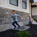 Custom Polycarbonate Window Well Cover with Kids Playing On It - Mountainland Covers 